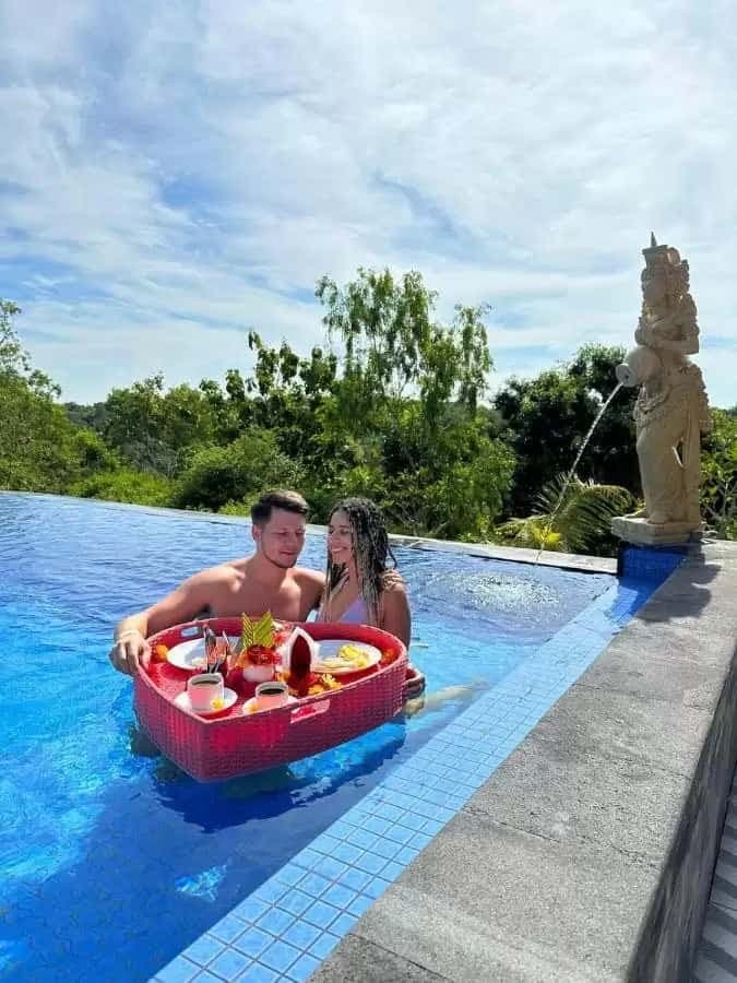 Couple enjoying floating breakfast in the infinity pool