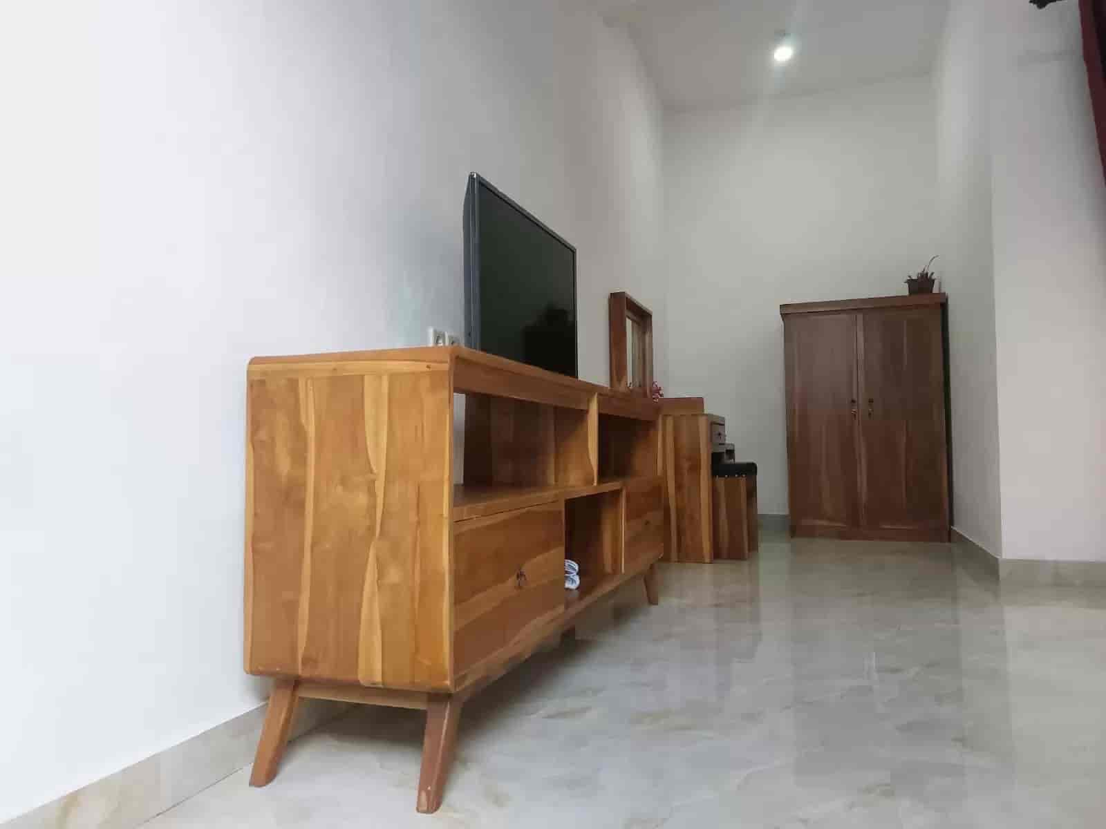 Room interior with teak furniture and flat screen TV